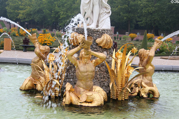 Gilded merman statues on Venus Fountain with triton figures blowing conch shells to calm the seas. Het Loo, Netherlands.