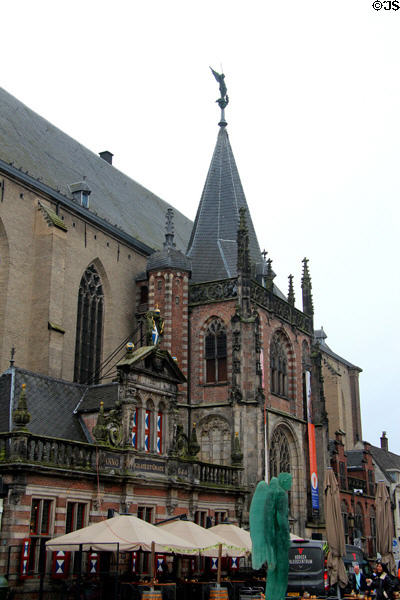 Spire of St. Michael's Church topped with statue of St. Michael & Glass Angel (2013) by Herman Lamers in foreground. Zwolle, Netherlands.