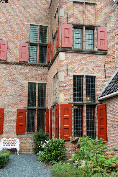 The brick walls, multi-paned windows & red shutters of ANNO Stadsmuseum Zwolle. Zwolle, Netherlands.
