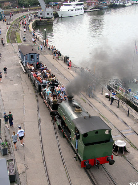 Steam locomotive taking passengers along Floating Harbour. Bristol, England.