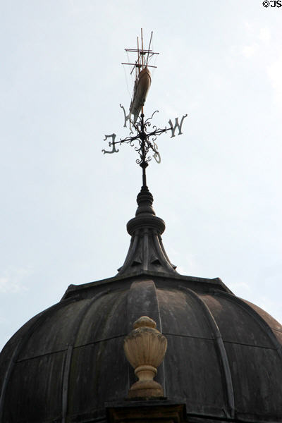 Weather vane with ship on vintage building. Bristol, England.