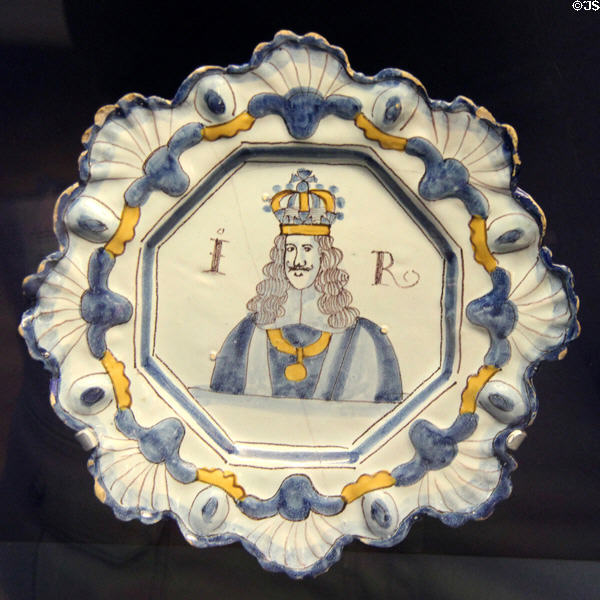 Ceramic plate (c1685-8), with scalloped edges & portrait & initials of James II, made in Brislington near Bristol at Bristol Museum & Art Gallery. Bristol, England.