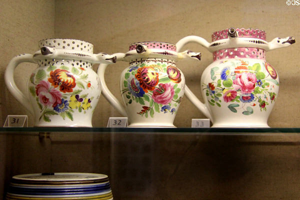 Earthenware puzzle jugs with bold floral designs (c1823-5) made at Bristol Pottery factory at Bristol Museum & Art Gallery. Bristol, England.