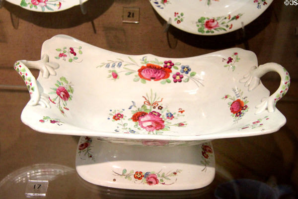 Ceramic floral serving plate on stand (1828) in Mansion House pattern, made at Bristol Pottery at Bristol Museum & Art Gallery. Bristol, England.