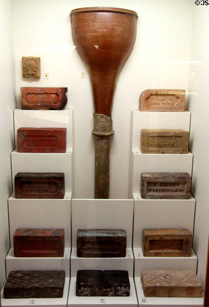 Display of clay fired bricks & salt-glazed stoneware rainwater head & down pipe (early 20thC) made in Bristol at Bristol Museum & Art Gallery. Bristol, England.