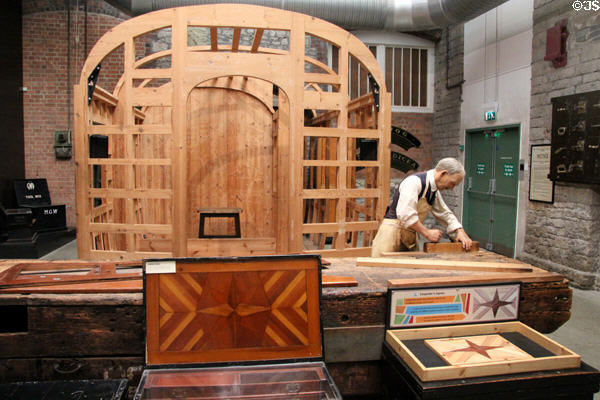 Carpenter using jigsaw to cut patterns needed by railway at STEAM Museum of Great Western Railway. Swindon, England.