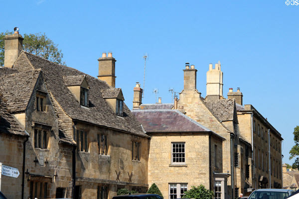 Row of Cotswold stone buildings with slate roofs on High St. Chipping Campden, England.