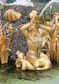 Detail of gilded merman statue on Venus Fountain with triton figure blowing conch shell to calm the seas. Het Loo, Netherlands.