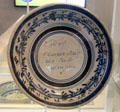 Stoneware dish with decorated rim & Dutch script in the center at ANNO Stadsmuseum Zwolle. Zwolle, Netherlands.