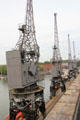 Row of antique cranes used when many ships laden with goods docked at Floating Harbour. Bristol, England.