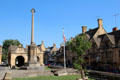War memorial to men of town who died during WWI with market hall in background on High St. Chipping Campden, England.