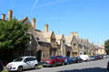 Cotswold stone buildings of various eras lining High St. Chipping Campden, England.